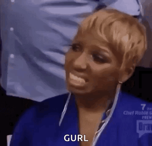 A Woman In A Blue Shirt Is Making A Funny Face With Her Tongue Out And The Word Curl Written On Her Face . GIF
