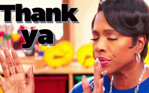 A Woman In A Blue Shirt Is Making A Thank You Gesture GIF