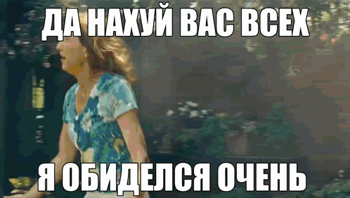 A Woman In A Blue Shirt Is Standing In Front Of A Sign That Says " Da Haxyu Bac Bcex " GIF