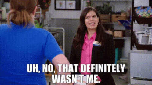 A Woman In A Blue Shirt Is Standing Next To A Woman In A Pink Shirt . GIF