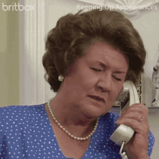 A Woman In A Blue Shirt Is Talking On A Phone With The Words Britbox Keeping Up Appearances Behind Her GIF