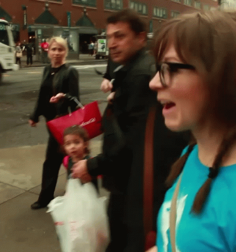 A Woman In A Blue Shirt Is Talking To A Man And Child GIF