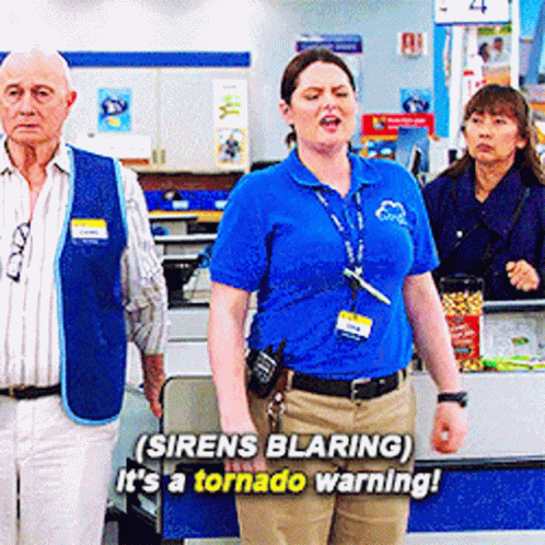 A Woman In A Blue Shirt Says Sirens Blaring It 'S A Tornado Warning In A Store GIF