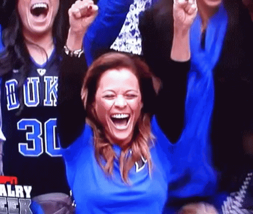 A Woman In A Blue Shirt With The Number 30 On It Is Laughing GIF