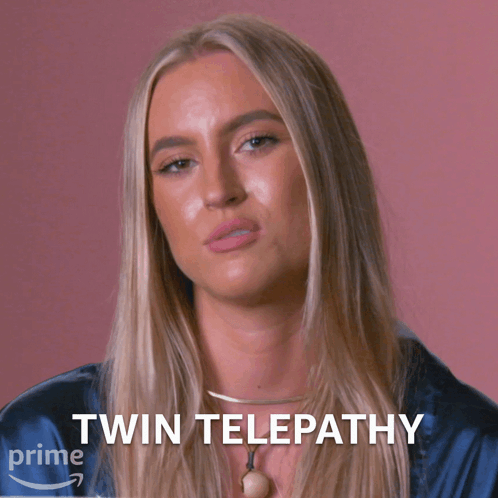 A Woman In A Blue Shirt With The Words Twin Telepathy On The Bottom Right GIF