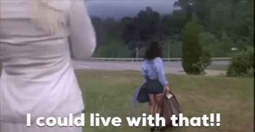 A Woman In A Blue Skirt Is Walking In A Field With The Words `` I Could Live With That '' . GIF