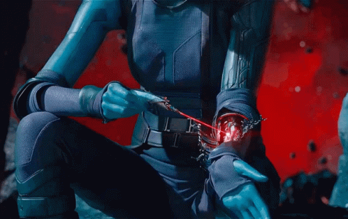 A Woman In A Blue Suit Holds A Red Object In Her Hand GIF
