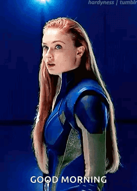A Woman In A Blue Suit Is Standing In Front Of A Blue Background And Says Good Morning . GIF