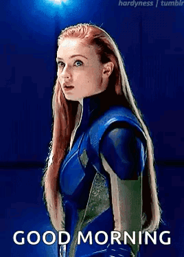 A Woman In A Blue Suit Is Standing In Front Of A Blue Background With The Words `` Good Morning '' . GIF