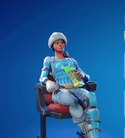 A Woman In A Blue Sweater Is Sitting On A Chair Holding A Book In Her Hand GIF