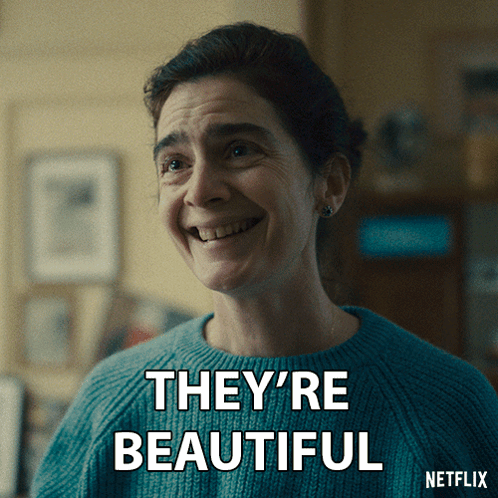 A Woman In A Blue Sweater Is Smiling With The Words They 'Re Beautiful Below Her GIF