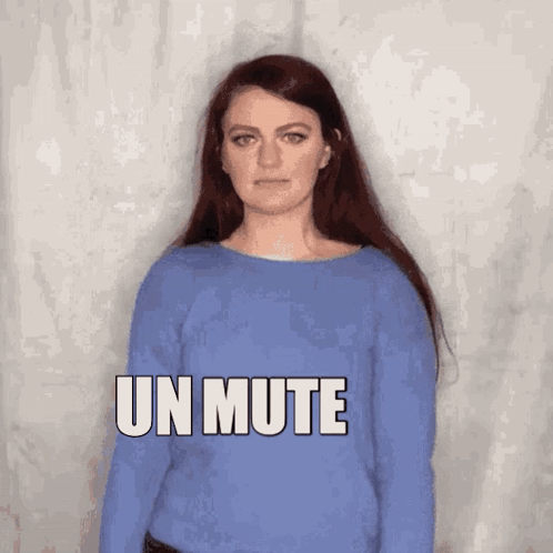 a woman in a blue sweater says un mute in white letters