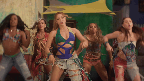 a woman in a blue swimsuit is surrounded by other women
