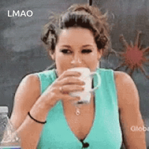 A Woman In A Blue Tank Top Is Drinking A Cup Of Coffee GIF
