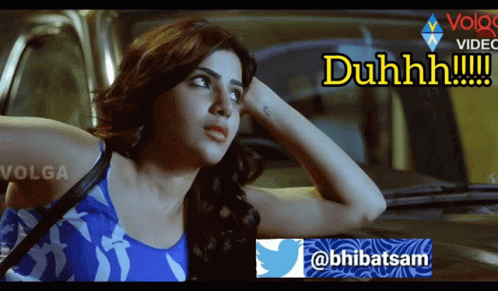A Woman In A Blue Tank Top Is Sitting In A Car With The Words Duhhhh Written On The Bottom GIF