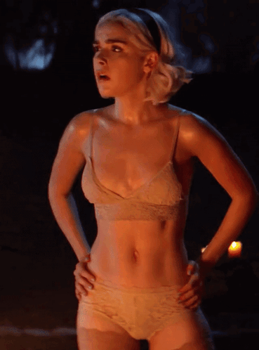 A Woman In A Bra And Panties Is Standing With Her Hands On Her Hips GIF