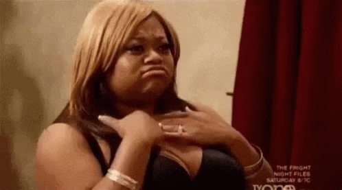A Woman In A Bra Is Making A Funny Face . GIF
