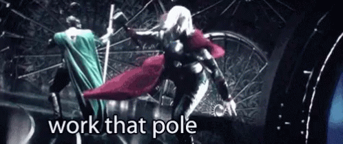 A Woman In A Cape Is Standing On A Pole With The Words `` Work That Pole '' Above Her . GIF