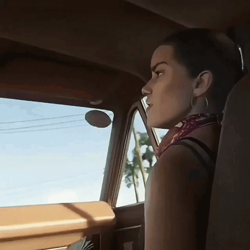 A Woman In A Car Looking Out The Window With A Palm Tree In The Background GIF