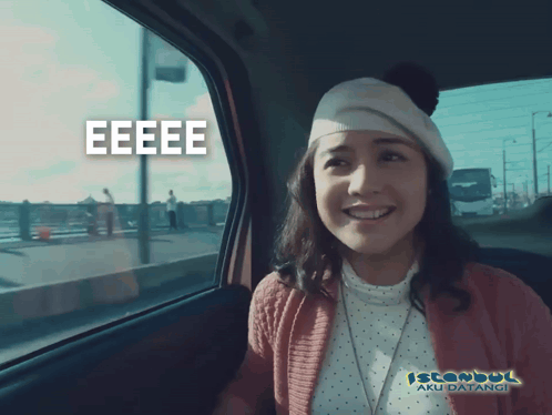 A Woman In A Car With Istanbul Aku Datangi Written On The Bottom Right GIF