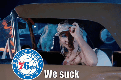 a woman in a car with the philadelphia 76ers logo