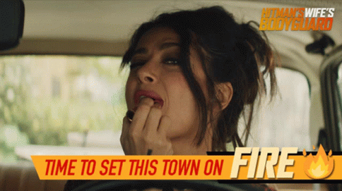 A Woman In A Car With The Words Time To Set This Town On Fire GIF