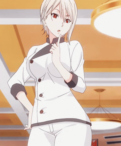 A Woman In A Chef 'S Uniform Is Standing With Her Hand On Her Chin GIF