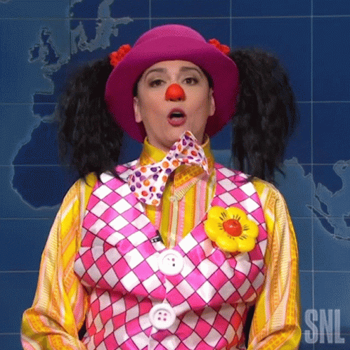 A Woman In A Clown Costume Is Making A Funny Face With Her Mouth Open . GIF