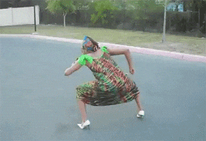 a woman in a colorful dress is dancing on a road