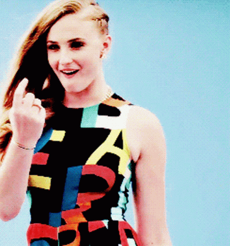 A Woman In A Colorful Dress With The Letter A On It Is Giving The Middle Finger GIF