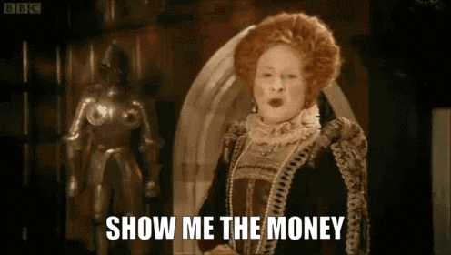 A Woman In A Costume Says Show Me The Money In Front Of A Statue GIF