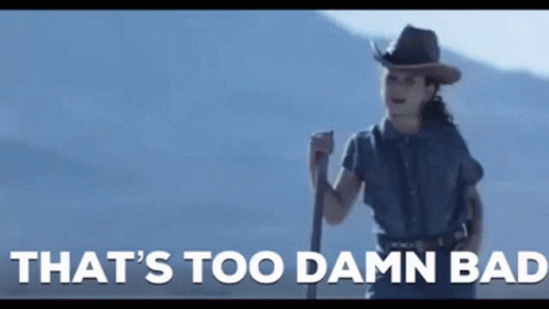 A Woman In A Cowboy Hat Is Holding A Stick With The Words That 'S Too Damn Bad Written Below Her GIF