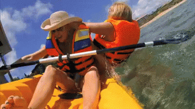 A Woman In A Cowboy Hat Is Paddling A Kayak GIF