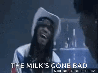 A Woman In A Cowboy Hat Is Smoking A Cigarette And Says `` The Milk 'S Gone Bad `` . GIF