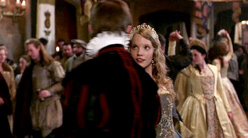 A Woman In A Crown Is Dancing With A Man In A Black Jacket GIF