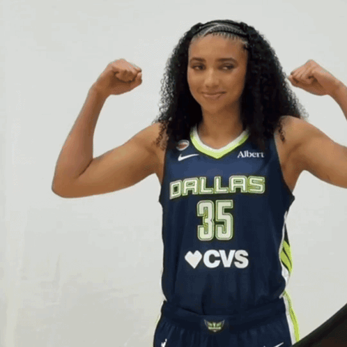 A Woman In A Dallas 35 Cvs Jersey Flexes Her Muscles GIF