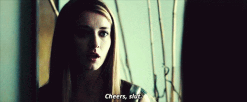 A Woman In A Dark Room Says Cheers , Slut GIF