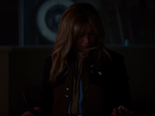 A Woman In A Dark Room With Her Hands Out GIF
