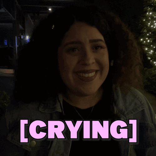 A Woman In A Dark Room With The Word Crying Above Her GIF