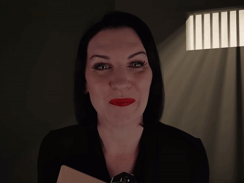 A Woman In A Dark Room With The Words " How Long Have You Been Possessed " Above Her GIF