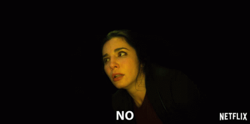 A Woman In A Dark Room With The Words No On The Bottom Right GIF