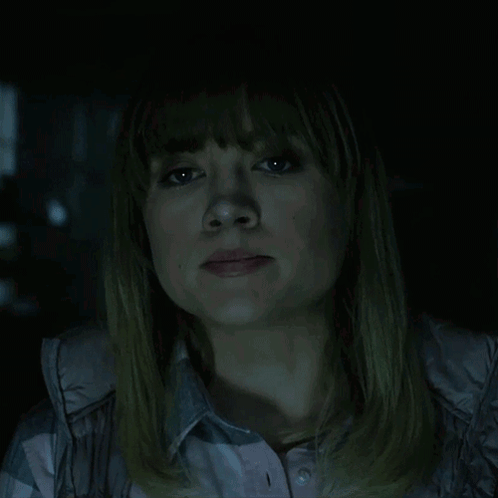 A Woman In A Dark Room With The Words Of Course Written Above Her GIF