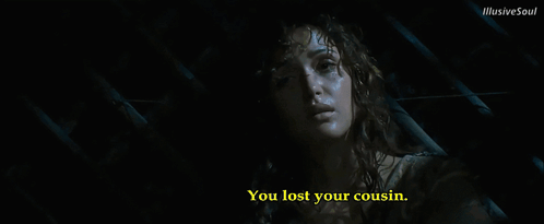 A Woman In A Dark Room With The Words You Lost Your Cousin Below Her GIF
