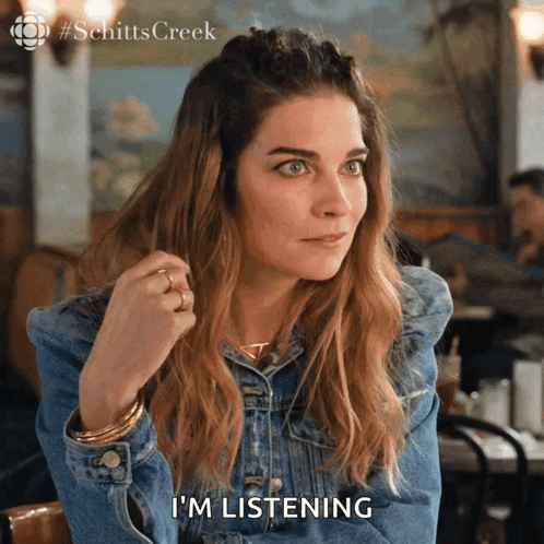 Woman In Denim Jacket Saying I'm Listening GIF