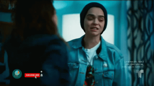 A Woman In A Denim Jacket Is Talking To Another Woman In A Beanie GIF