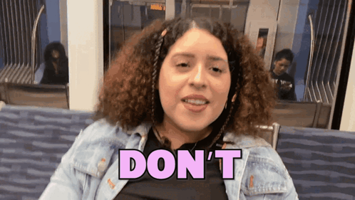 A Woman In A Denim Jacket Says " Don 'T " GIF