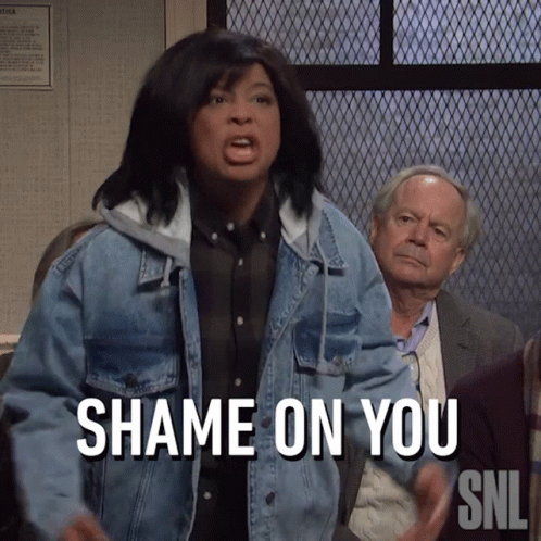 A Woman In A Denim Jacket Says " Shame On You " In Front Of A Group Of People GIF