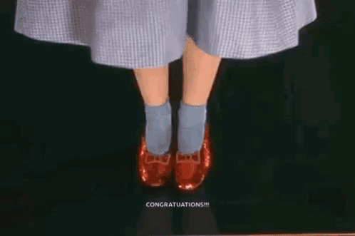 A Woman In A Dress And Blue Socks Is Wearing Red Shoes . GIF