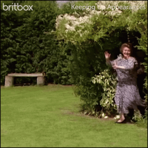 A Woman In A Dress Is Standing In A Garden With The Words Britbox Keeping Up Appearances On The Bottom GIF