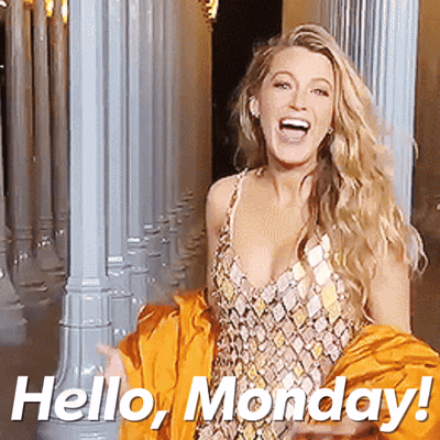 a woman in a dress is standing in front of columns and says hello monday
